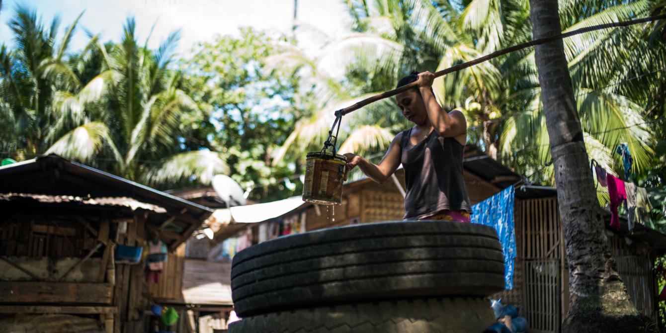 A resident of Gumaga in Libungan, Cotabato, fetches water from a deep well, which used to be their main source of water for years. Through SIMCARRD and Oxfam—and with counterpart funding from the barangay local government—almost 60 families in the area now have access to clean and safe water from a newly installed water point. (Photo: Jed Regala/Oxfam)